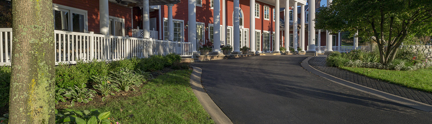 Couple enjoying the rocking chairs on the porch of the Inn at Black Star Farms.