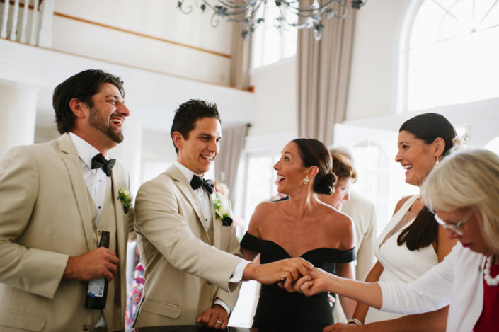 Bride, groom and guests in the front foyer at the Inn at Black Star Farms.