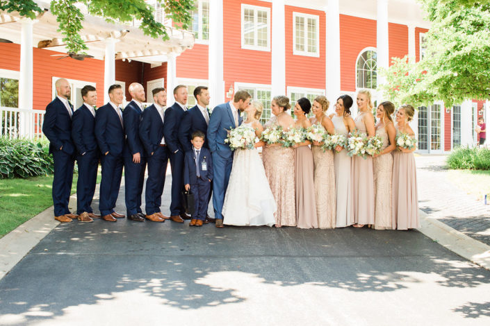 Wedding party standing in front of the Inn at Black Star Farms.