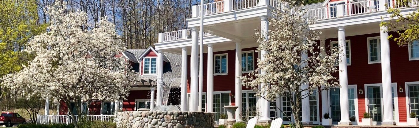 The Inn at Black Star Farms during spring with Magnolia trees blooming.