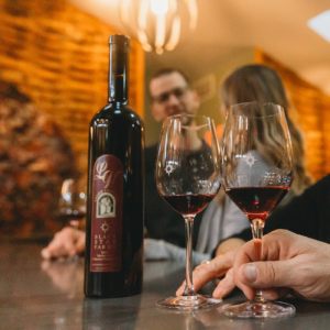 People tasting premium red wine in the members-only Barrel Room at Black Star Farms Suttons Bay.