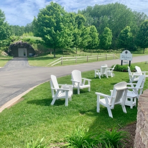 Adirondack chairs on the lawn at the Suttons Bay tasting room.