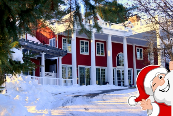 Santa waving in front of the Inn.