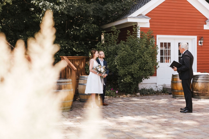 Elopement couple with officiant.