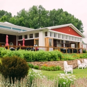 People enjoying the patio at the Suttons Bay tasting room at one of the best Leelanau Peninsula wineries