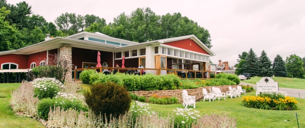 People enjoying the patio at the Suttons Bay tasting room at one of the best Leelanau Peninsula wineries