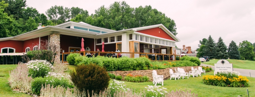 People enjoying the patio at the Suttons Bay tasting room at one of the best Leelanau Peninsula wineries