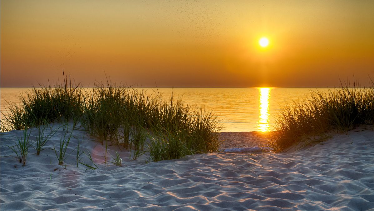 Sun setting on Lake Michigan beach.