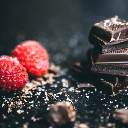 Fresh raspberries and chocolate squares.