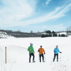 People snowshoeing Black Star Farms trail.