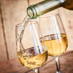 Pouring white wine into a glass.