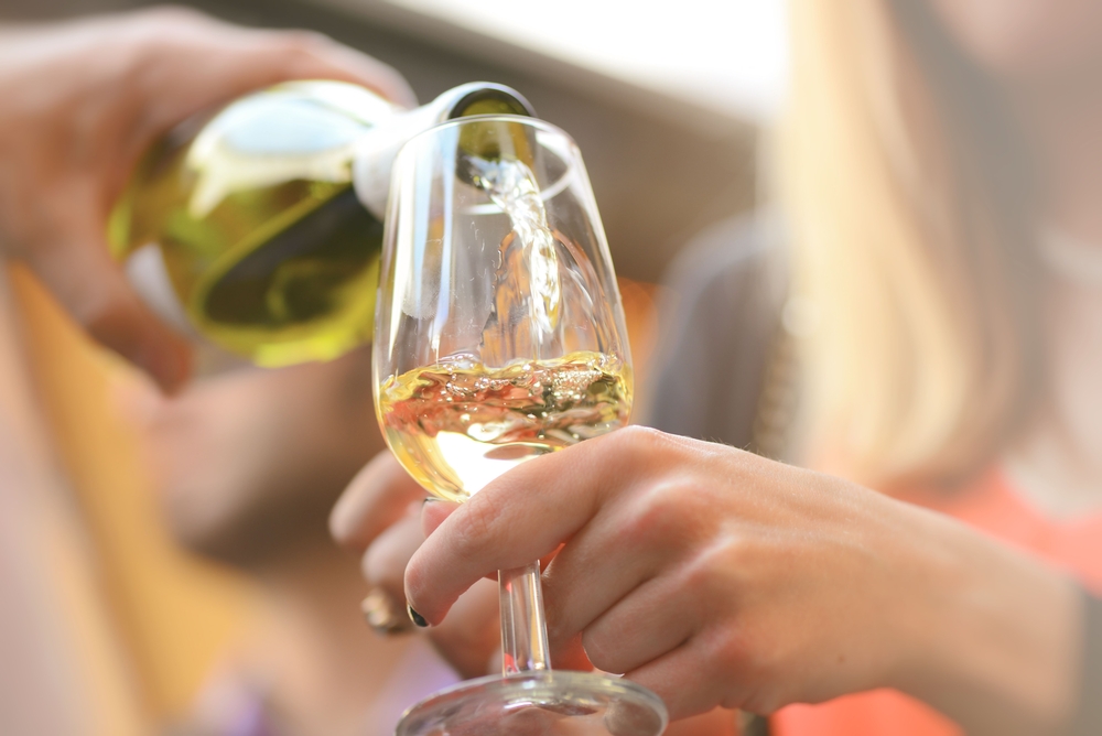 Woman drinking white wine at the best Suttons Bay Wineries in Michigan