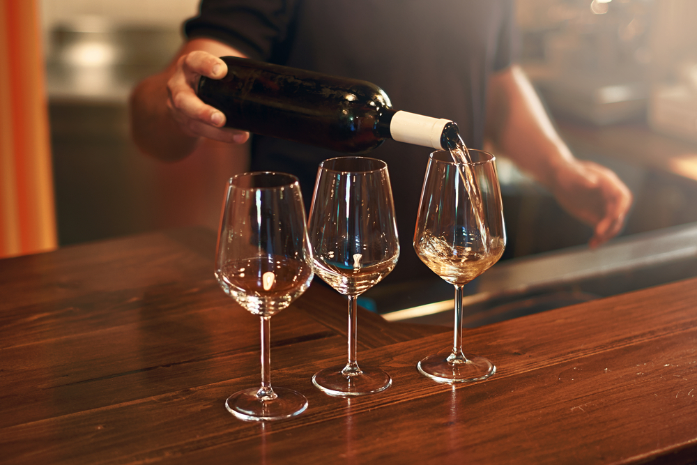 Sommelier pouring wine during a wine tasting in Traverse City