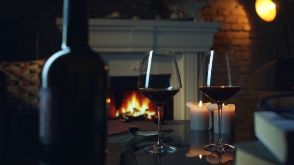 Glasses of red wine by the fireplace - a cozy winter wine tasting on the Leelanau Peninsula Wine Trail