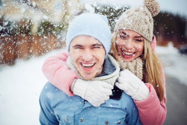 A young couple enjoying all the romantic things to do in Traverse City while enjoying a romantic getaway in Michigan this winter