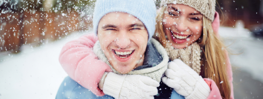 A young couple enjoying all the romantic things to do in Traverse City while enjoying a romantic getaway in Michigan this winter