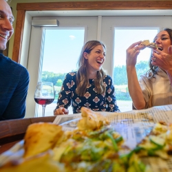 People enjoying pizza and wine at the bistro.