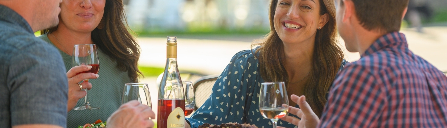 People enjoying food and wine on the patio at Bistro Polaris.