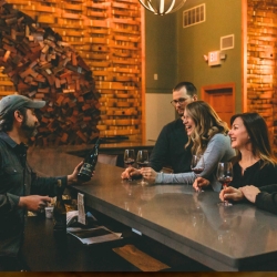 A man presenting wine in the Barrel Room.